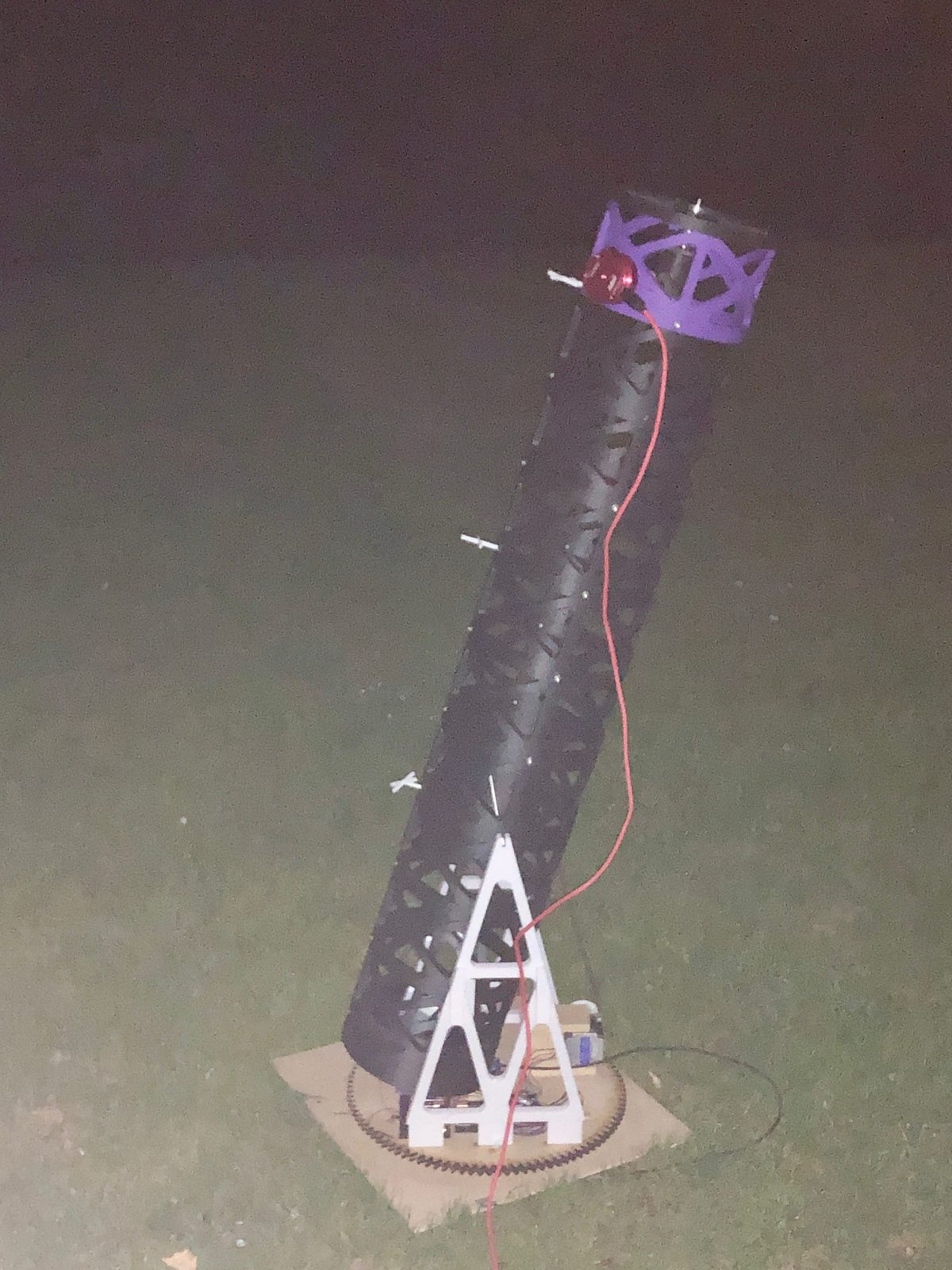 Assembled telescope on a 3D-printed mount, set up outdoors at night.